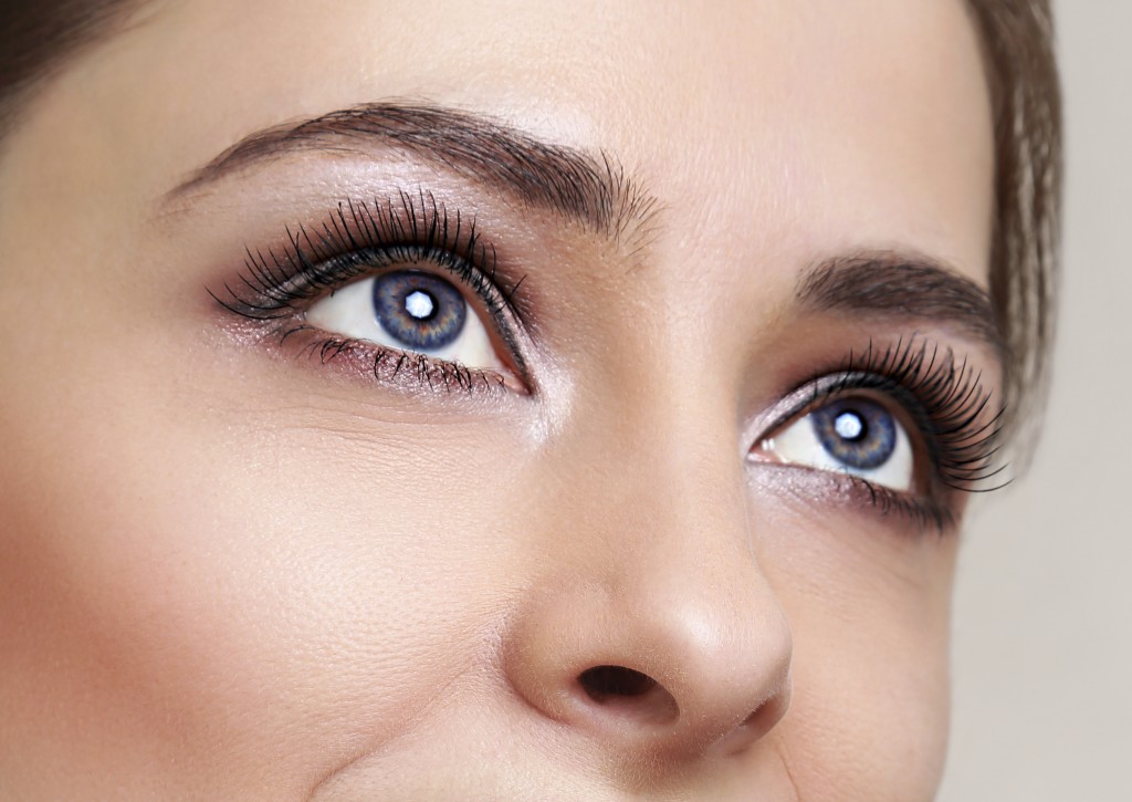 Beautiful blue woman eyes with long lashes looking