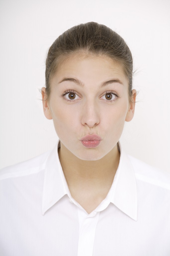 Young woman pursing her lips, portrait