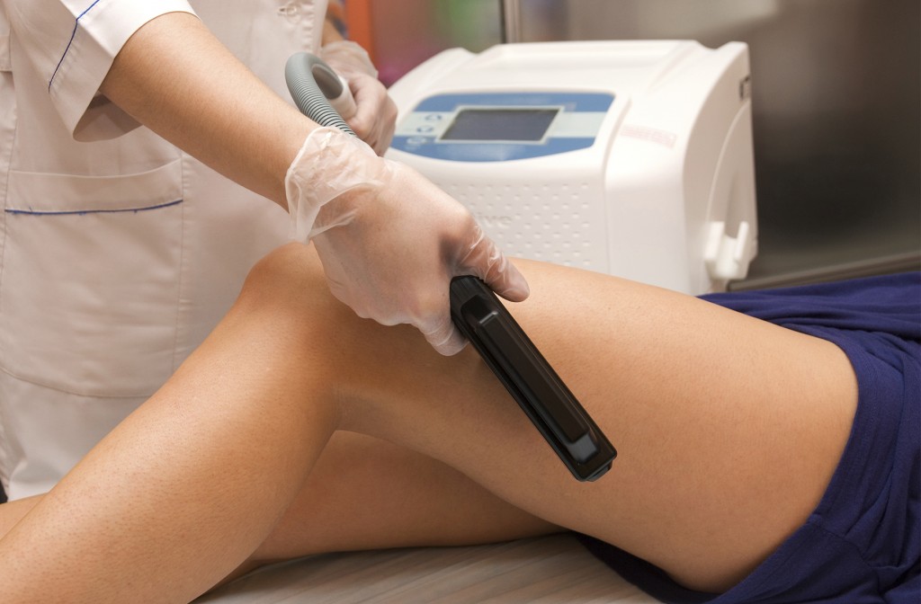 Laser epilation of leg in a modern beauty shop