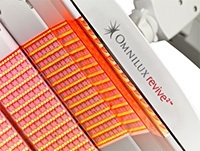 Glowing orange omnilux light therapy acne treatment device