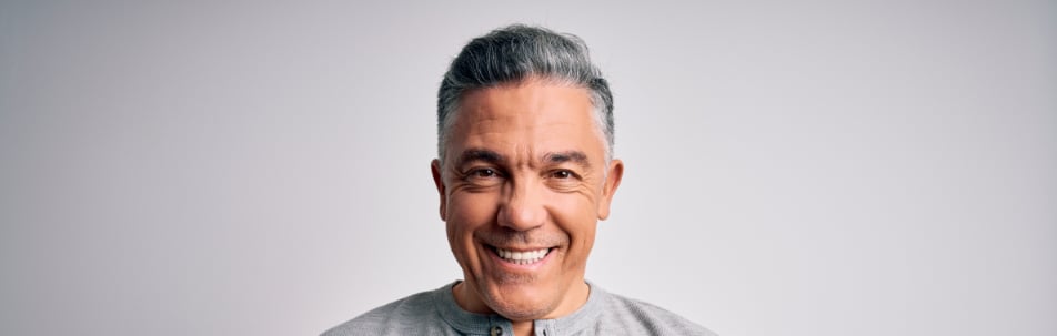 banner image of a man smiling at the camera