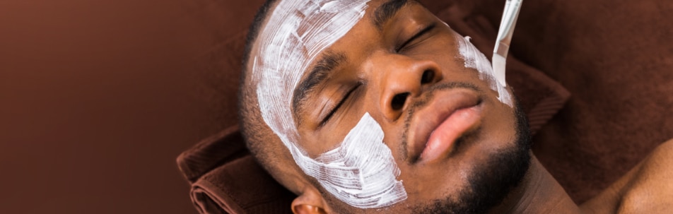 male patient getting a chemical peel on his face