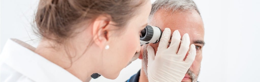 dermatologist inspecting skin moles on patient face picture id693844164