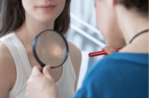 Dermatologist examining a girls neck area