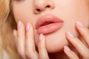 peach color of lipstick on large lips.