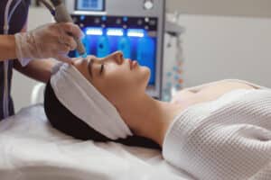 Woman receiving microdermabrasion treatment for skin texture