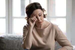 Woman stressed during the holidays and in need of skin care tips to prevent it from impacting her