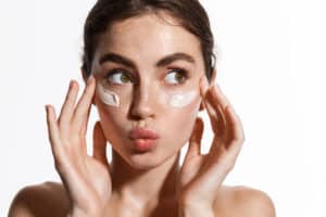 Woman with moisturizer on her face for acne treatment in LA