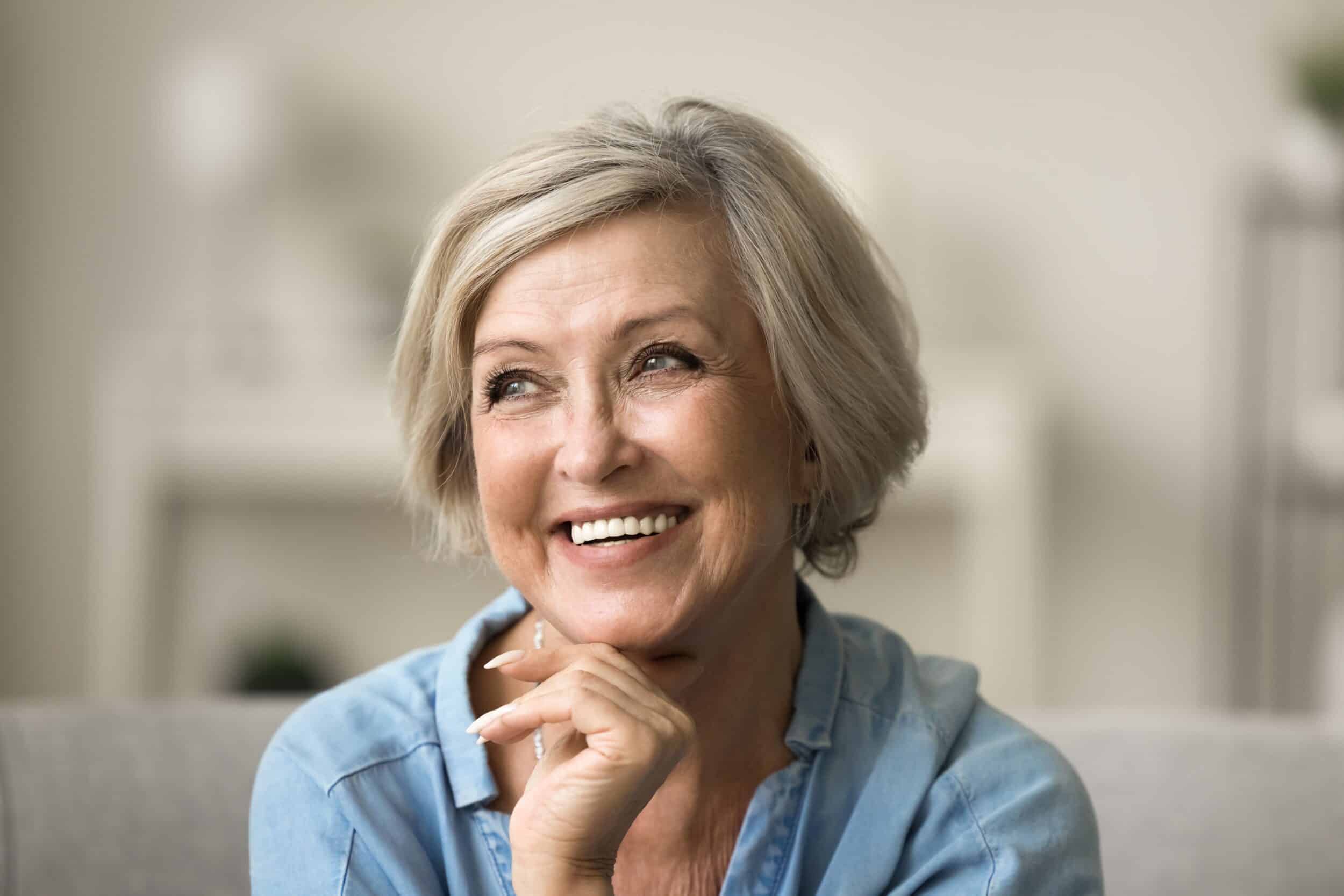 Older woman smiling with clear skin after Levulan PDT treatment for AKs in Los Angeles